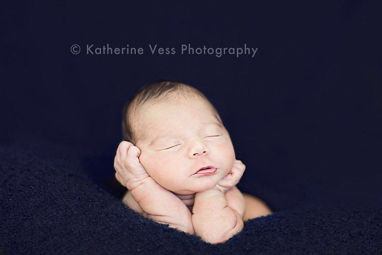 adorable newborn baby boy hand in chin post