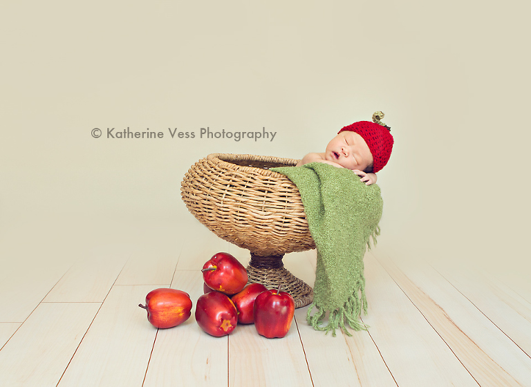 cute baby in apple basket