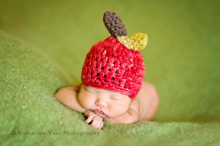 cute little newborn baby with apple