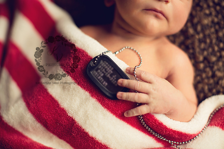 newborn with dog tags