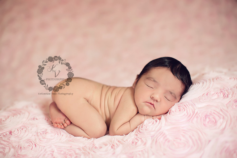 baby girl on pink roses