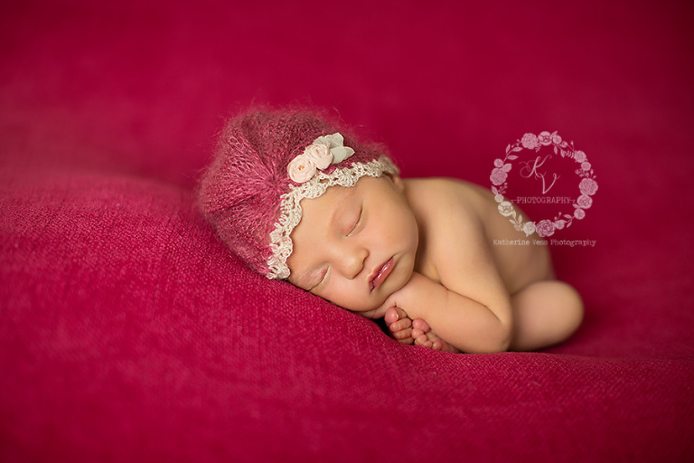 baby girl with cute little hat on bright pink