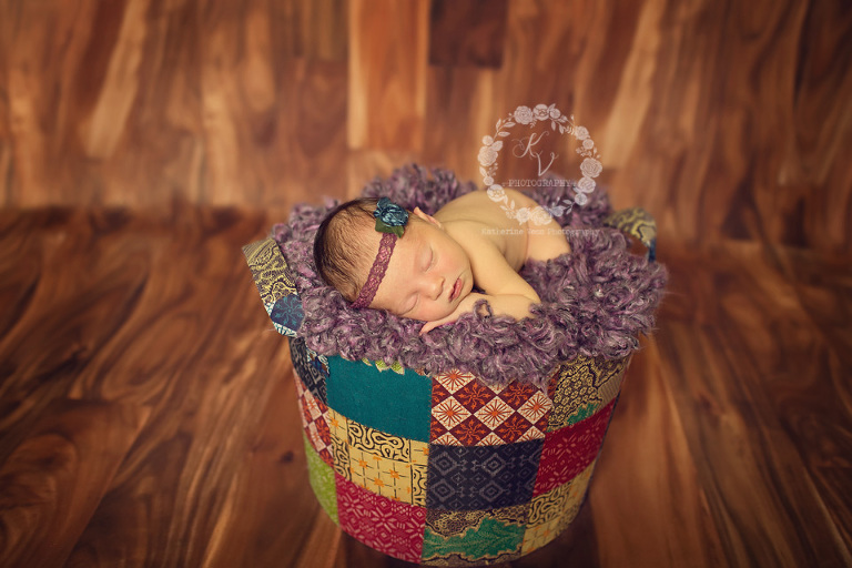 newborn in patchwork basket