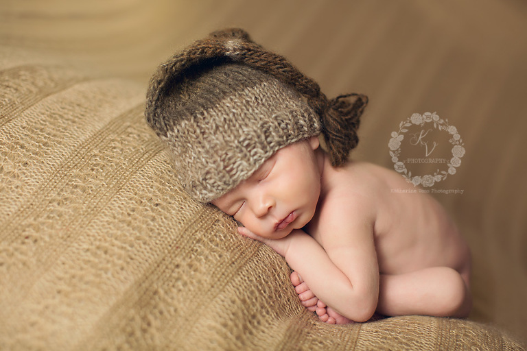 newborn in tassel hat