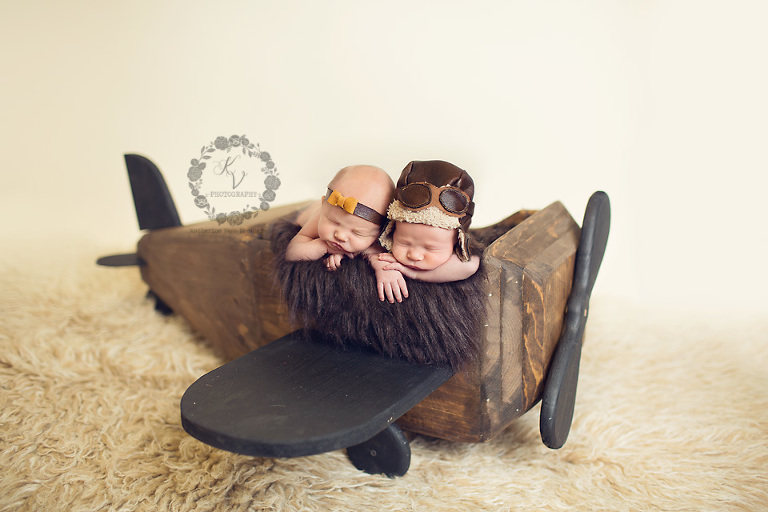 newborn twins in plane prop