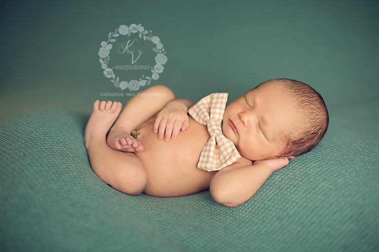 newborn in relaxed pose with tie