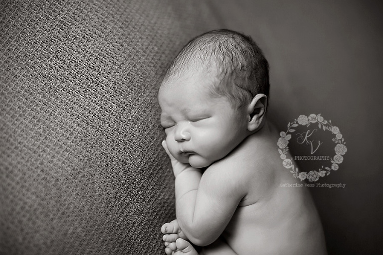 side angle of newborn in taco pose