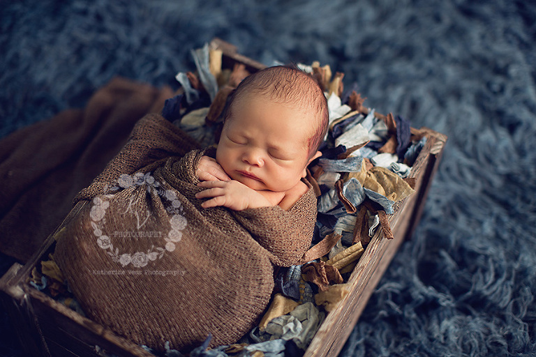 newborn in blue, brown