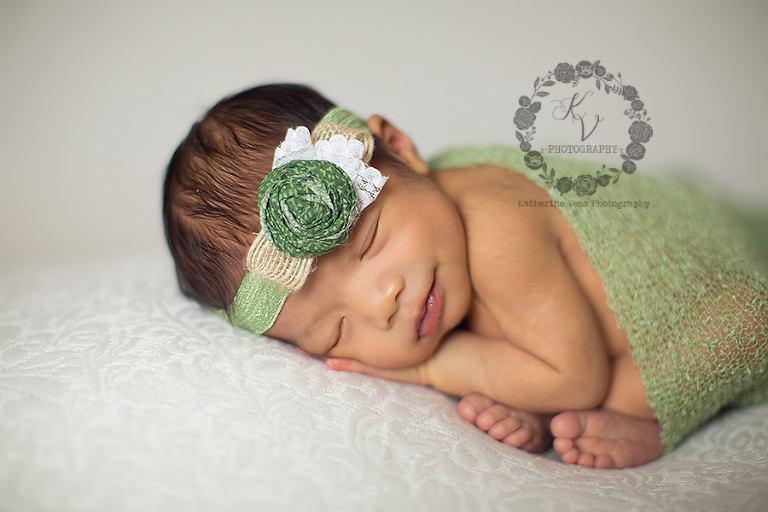 smiling baby girl in green