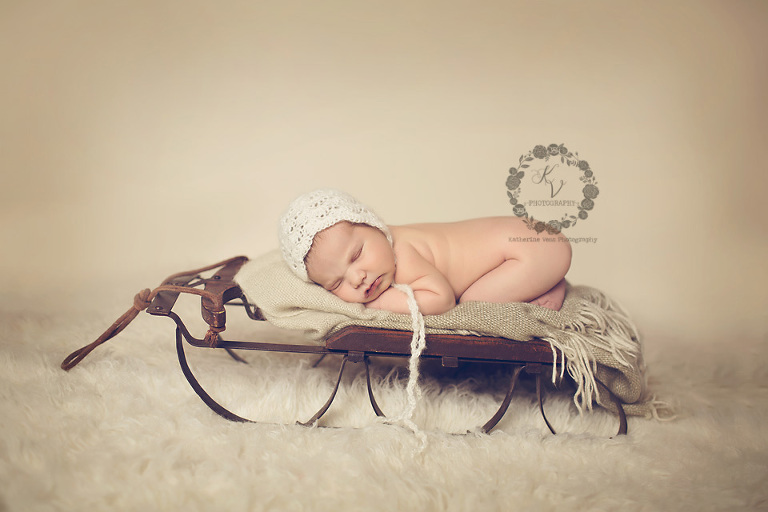 baby girl on sled