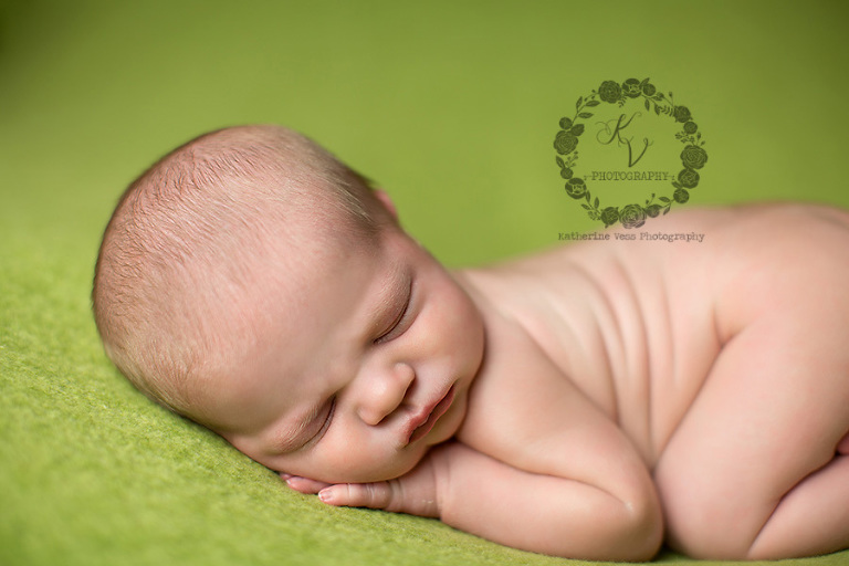 baby on green fabric