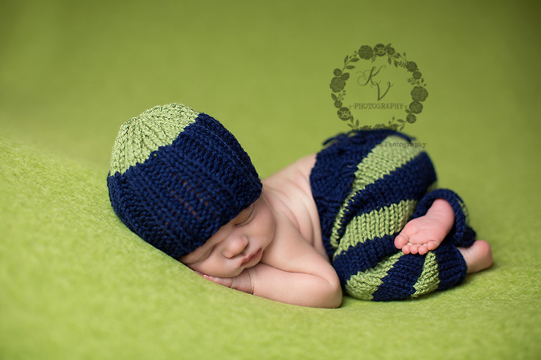 newborn in navy and green set up