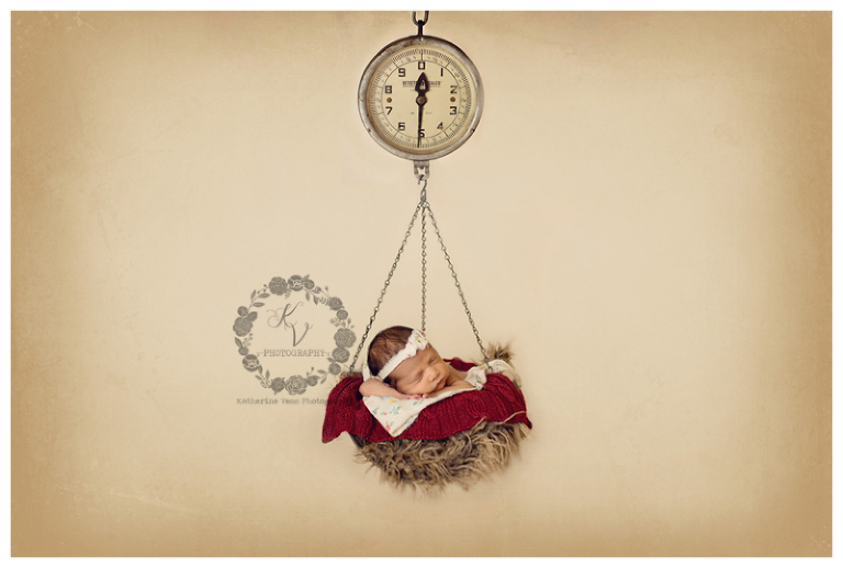 newborn in hanging scale