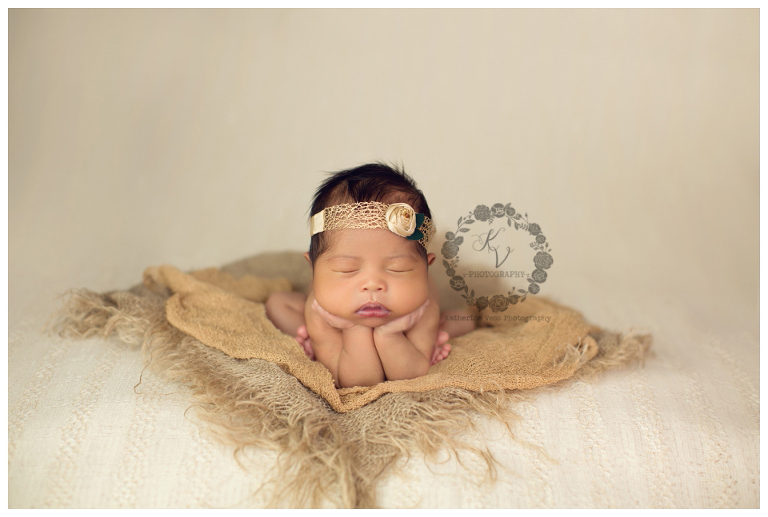 newborn girl head in hands pose