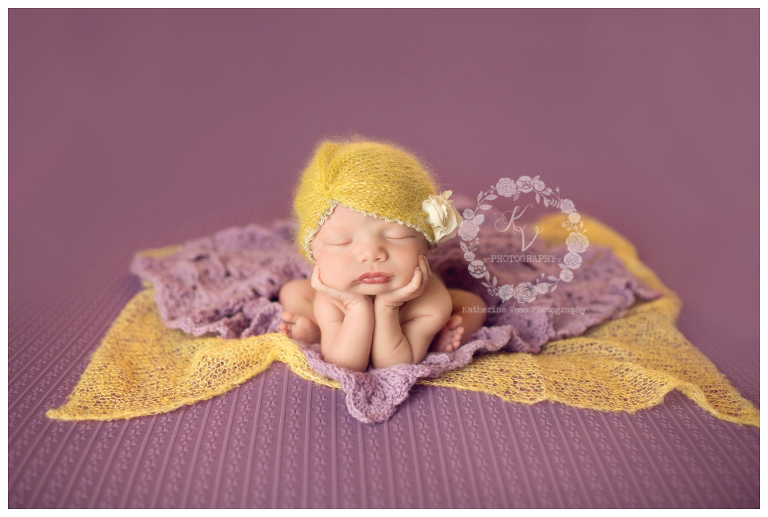 newborn girl with purple and yellow