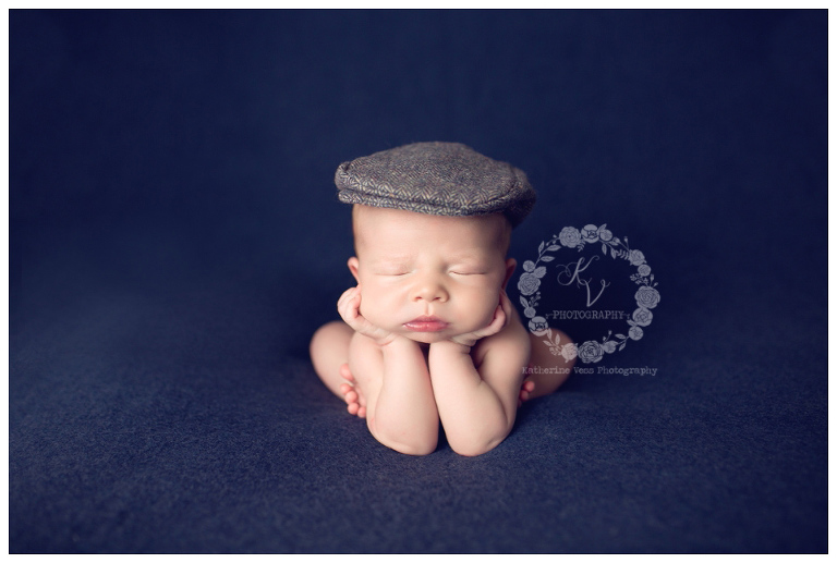 newborn in old newsboy cap